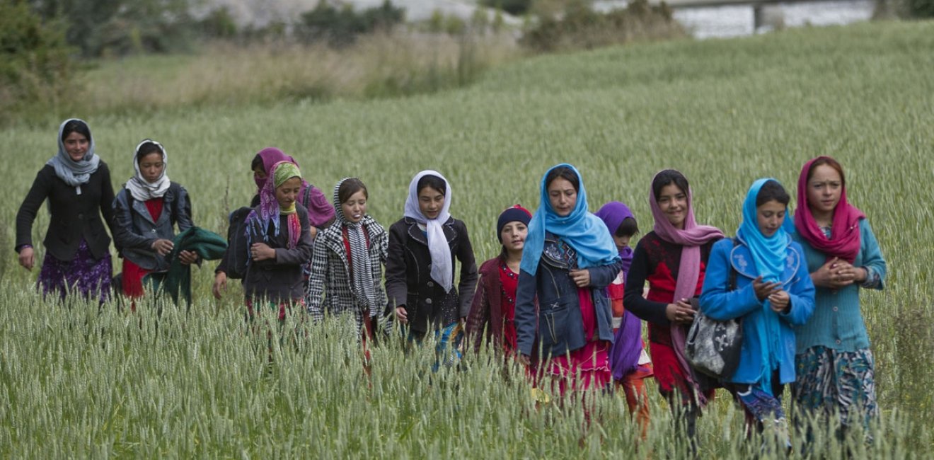 In this Thursday, Aug. 18, 2016 photo, young girls walk towards their school, in Wakhan, Badakhshan province, far northeastern Afghanistan.