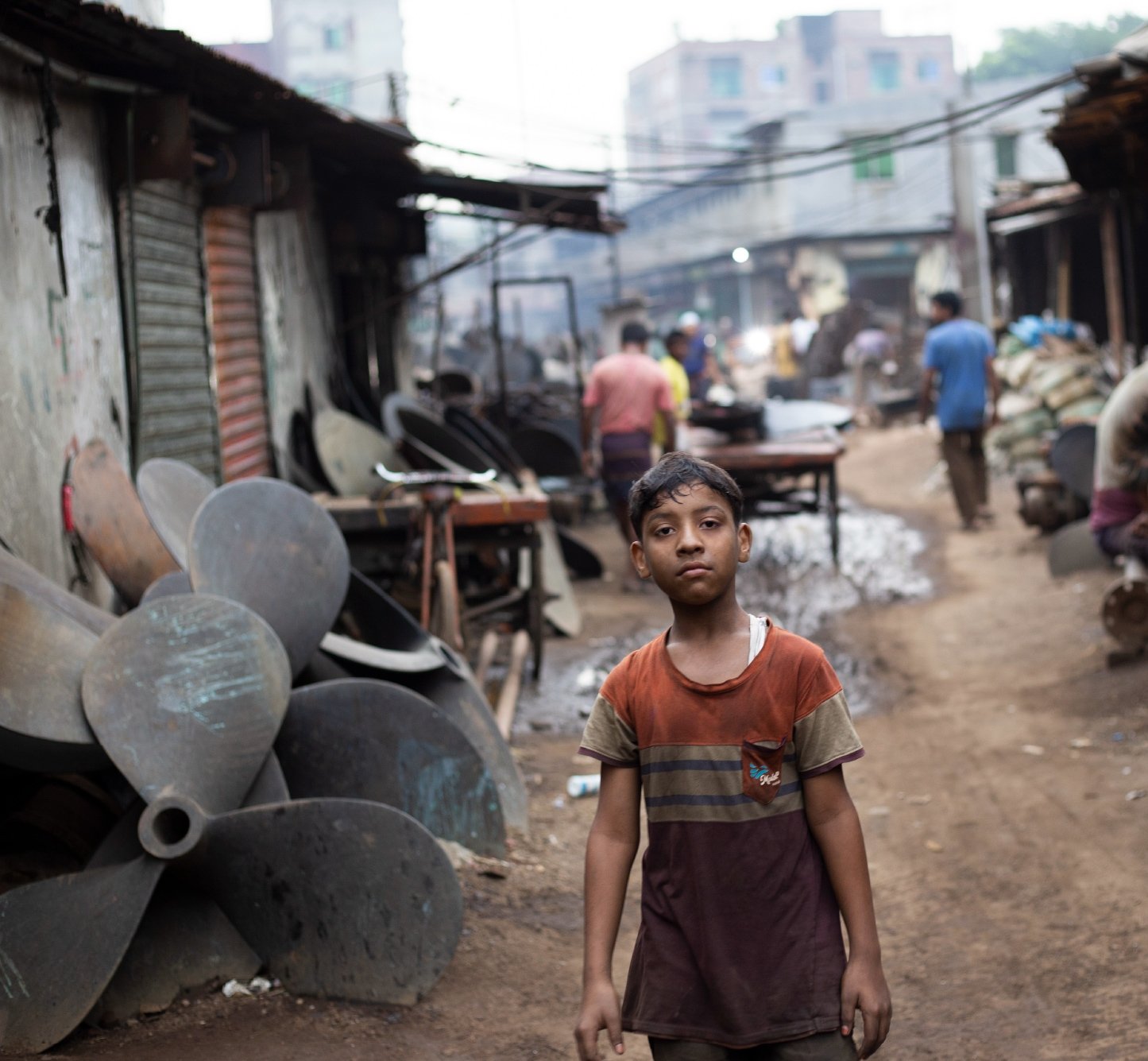 Bangladesh child looking at camera in an industrial area