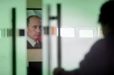 Image of Vladimir Putin behind closing door