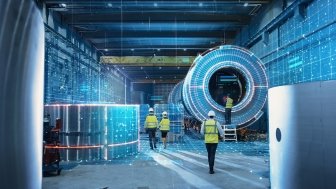 Workers in safety vests in a factory setting surrounded by futuristic technology.