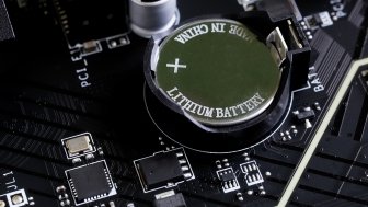 A battery on an electronics motherboard that says Lithium Ion, Made in China