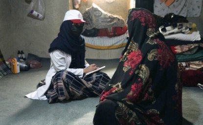 Afghan Red Crescent Mobile Health Team staff member providing essential health services to Afghan women.