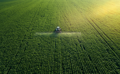 Aerial view of a tractor fertilizing a field