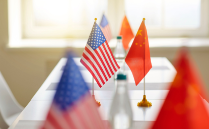 US and Chinese Flags Across a Table