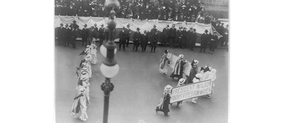 Suffragettes parading with banner "President Wilson favors votes for women". N.Y.C. , ca. 1916. Photograph. https://www.loc.gov/item/2001704196/.