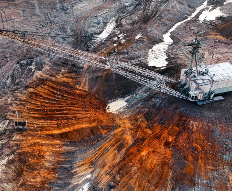 An excavator in a quarry extracting rare minerals.