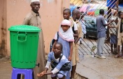 Students washing hands before entering their classroom