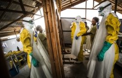  In Beni, North Kivu region, Democratic Republic of Congo, health workers put their Personal Protective Equipment on before entering the zone where people suspected of having Ebola are held in quarantine to be monitored and treated.