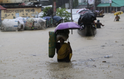 Women walking through flooded street, Bangladesh