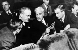 Three men in discussion in UN seats