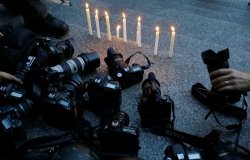 Cameras at a candlelight vigil