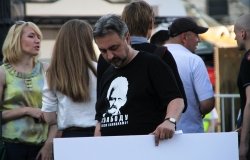 Man holding sign with shirt supporting  Ales Bialiatski